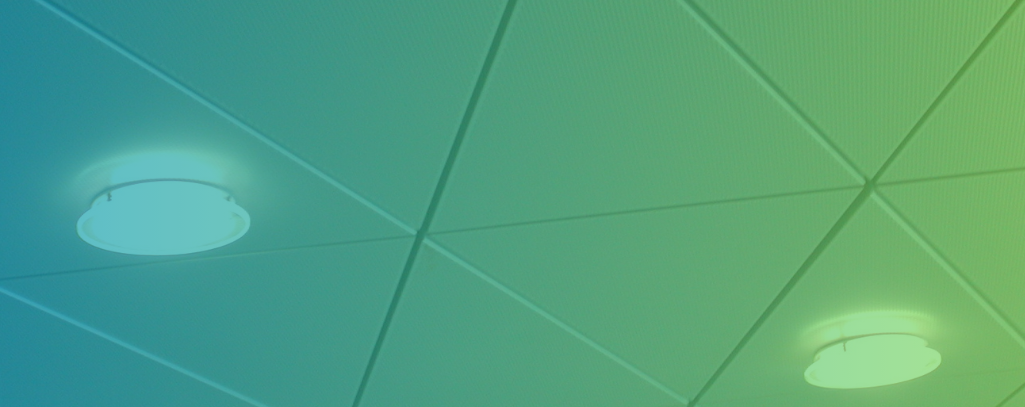 blue and green gradient over some ceiling lights